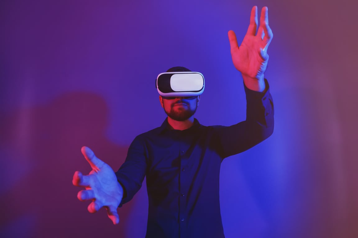 Young Man with Virtual Reality Glasses on Dark Color Background